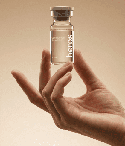 Hand holding a Heros-branded GLP-1 medication vial